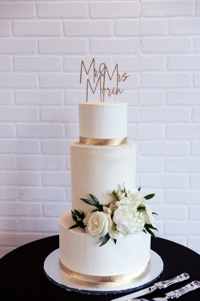 Clean and classic three tiered white and gold wedding cake