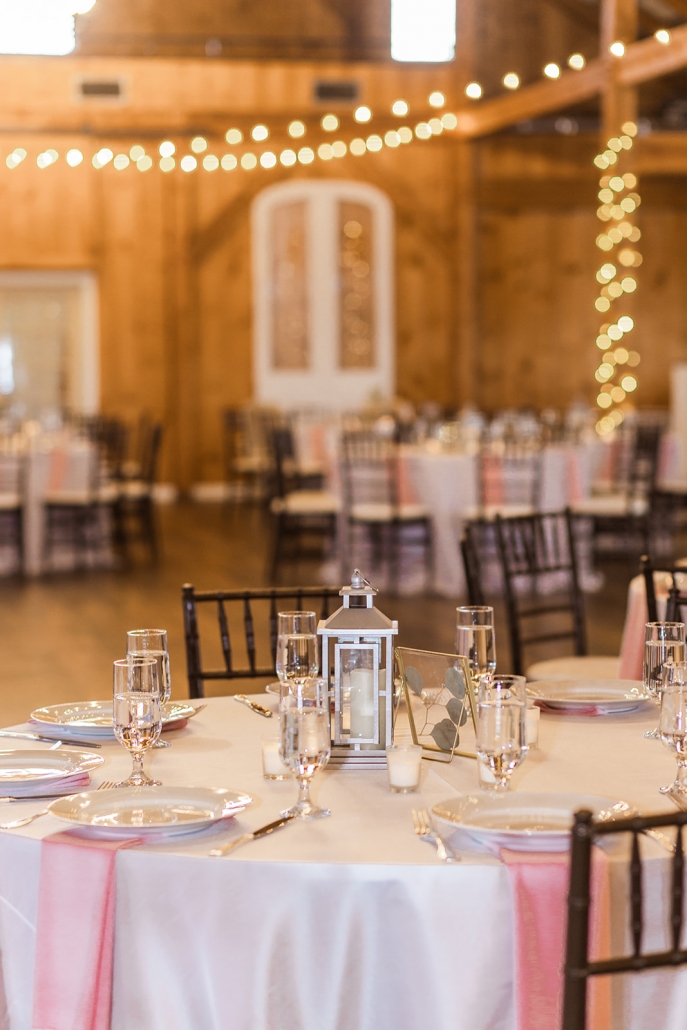 Barn reception table centerpiece with lantern and table numbers