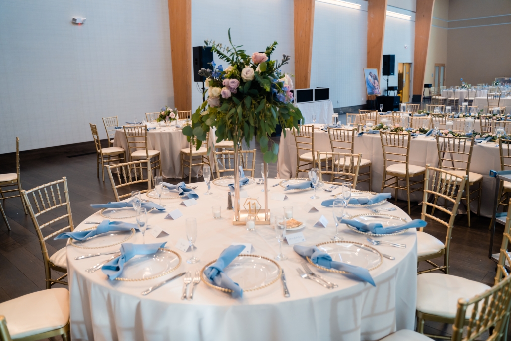 Indoor wedding reception design with gold and blue accents